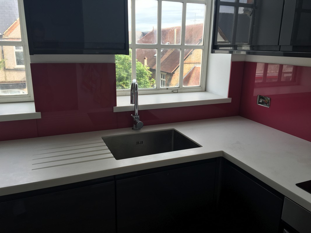 Deep plum coloured glass splashback in modern Barnes kitchen
