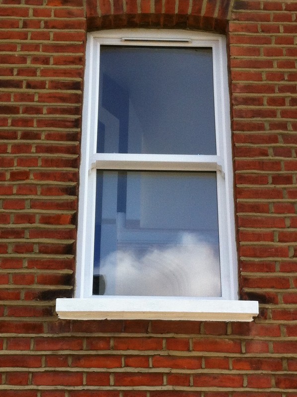 uPVC sash window on Victorian red brick house in Barnes